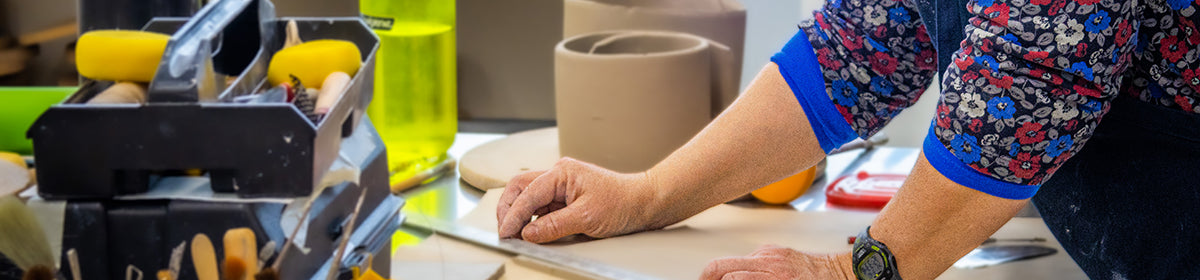 potter measuring clay