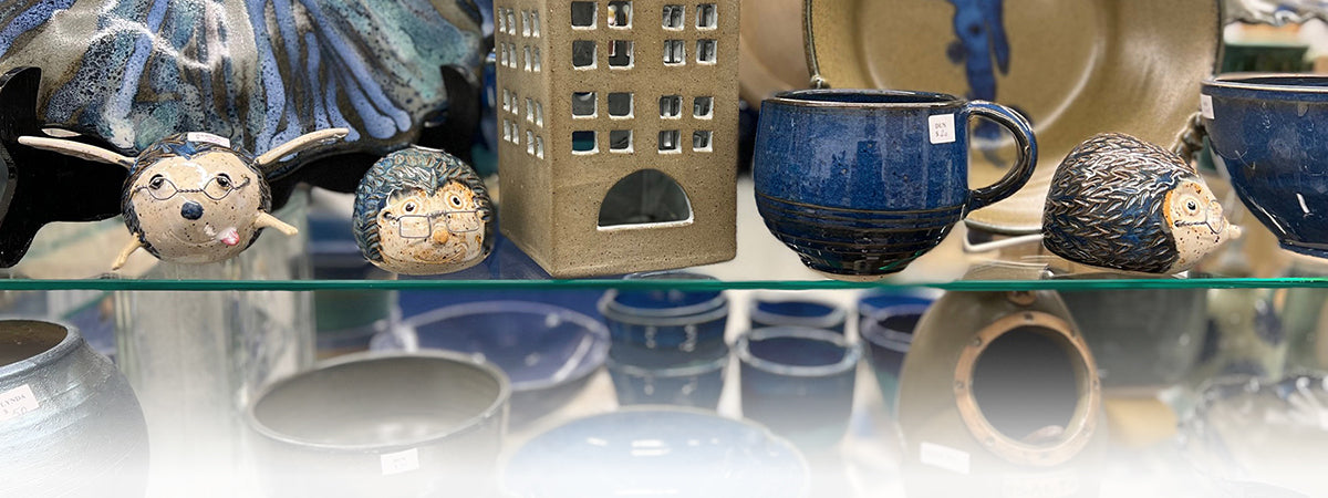 banner of ceramic pieces on a shelf